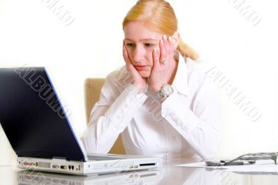 Pensive woman in front of the laptop