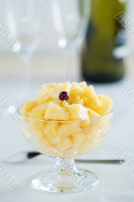 Pineapple dessert with glasses and bottle
