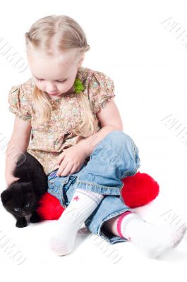 Little girl playing with kitten