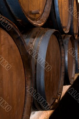 stacked wine barrels in the wine cellar 