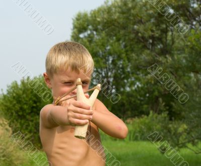 Child with a slingshot.