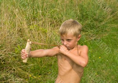 Child with a slingshot.