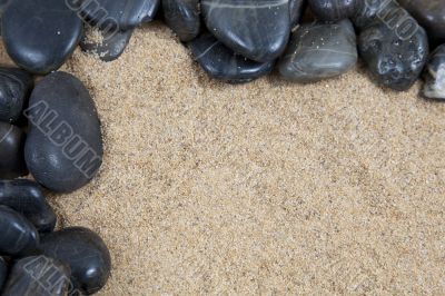 zen spa river rocks on sand in form of border