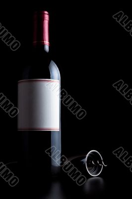 bottle of red wine and corkscrew