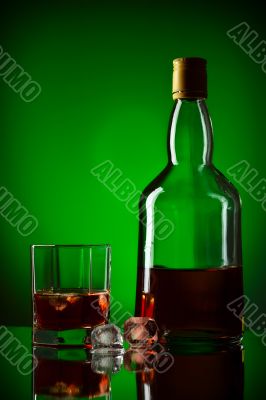 whiskey bottle, ice and glass