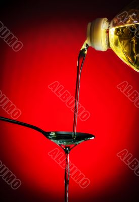 pouring oil on spoon