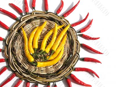 Red and yellow chili peppers on a wicker stand