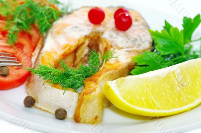 grilled fish with vegetables and slice of lemon