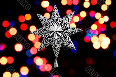 Decorative christmas star - on christmas lichts background..