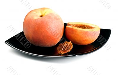 red peaches with pip on black dish