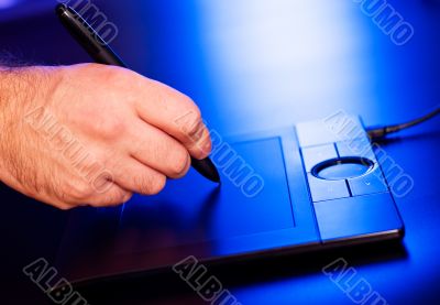 man`s hand on drawing tablet