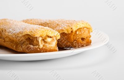 two eclairs on white dish