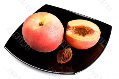 red peaches with pip on black dish