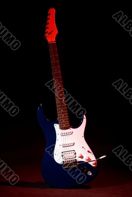 electric guitar in ray of red light