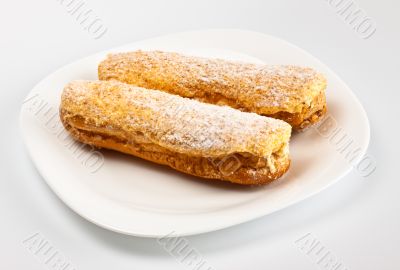 two eclairs on white dish