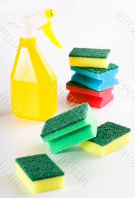 yellow spray bottle and multicolored sponges