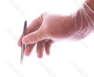 hand in rubber glove holding tweezers