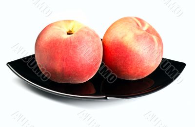 red peaches on black dish