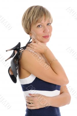 The woman holding her shoes