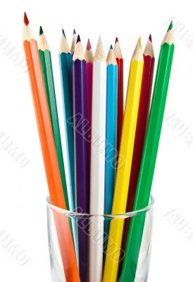 A glass cup with pencils
