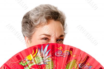 Senior woman with red dragon fan