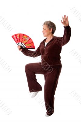 Senior woman doing Tai Chi Yoga exercise