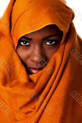 Mysterious female face in ocher head wrap