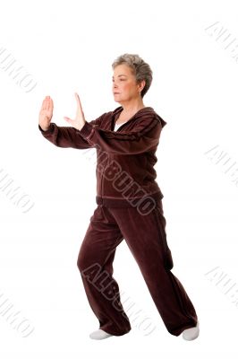 Senior woman doing Tai Chi Yoga exercise