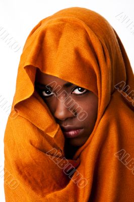 Mysterious female face in ocher head wrap