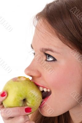 The girl eats a green apple