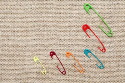 Safety Pins On Canvas