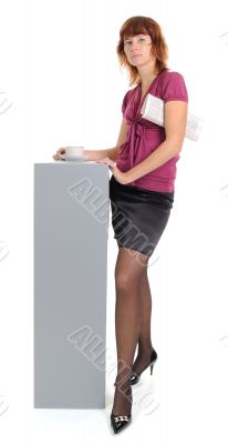 Female with the newspaper and a cup