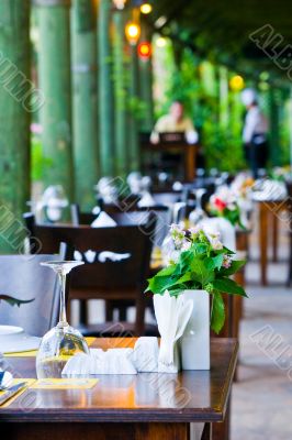 The served tables on a summer verandah 