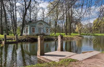 Spring landscape with an old building and the pier