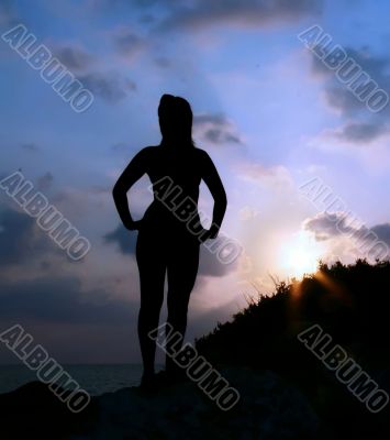 Silhouette of a girl against the sunset