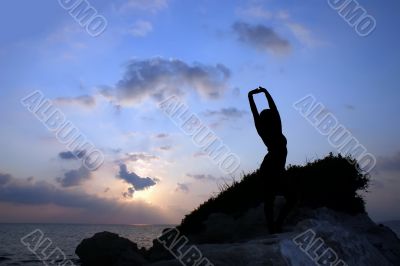 Silhouette of a girl against the sunset