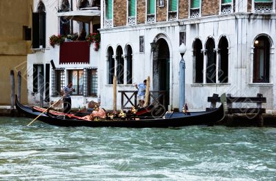 Venetian gondola and gondolier at the main canal of Venice. Ital