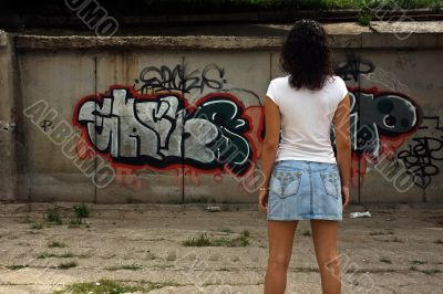 The beautiful girl against graffiti. 