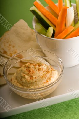 hummus dip with pita bread and vegetable