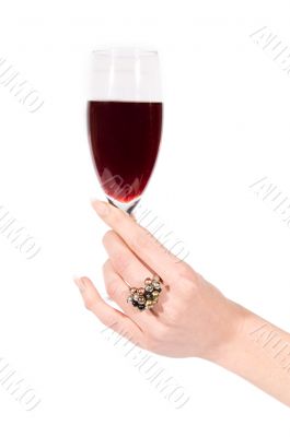 Woman hand with ring holding glass of wine