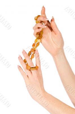Woman hands holding amber necklace