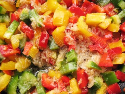 Yellow, red and green Bulgarian pepper in skillet