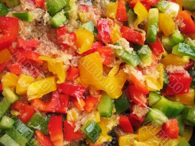 Yellow, red and green Bulgarian pepper in skillet