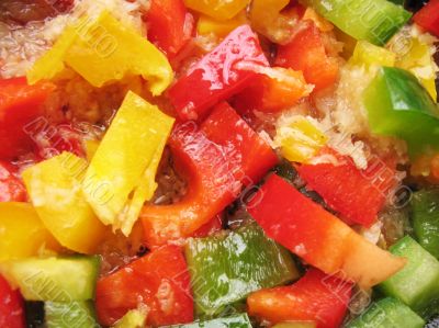 Yellow, red and green Bulgarian pepper in skillet