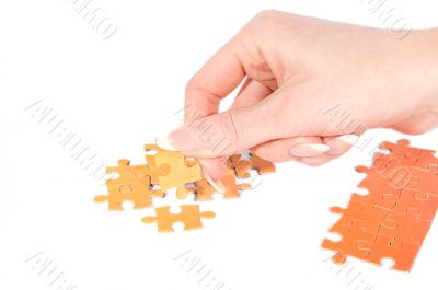 Woman hand putting right puzzle