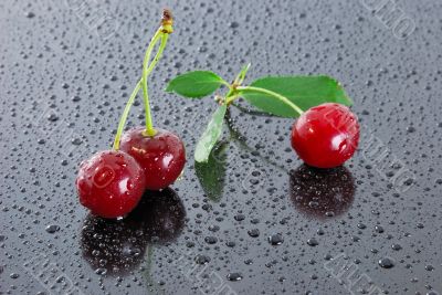 Three wet red cherries.
