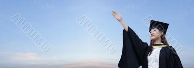 Asian lady graduate raising hand