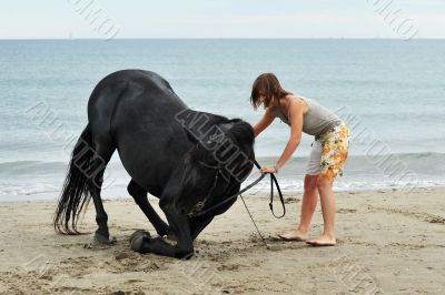 girl and  horse on the beach