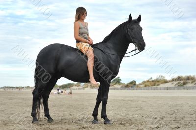 woman and  horse on the beach