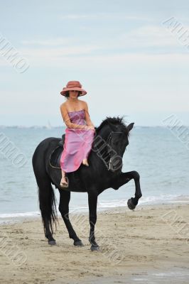 girl and  horse on the beach